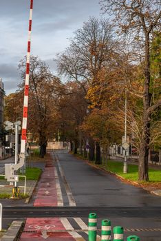 Empty street with open train barrier in Autumn