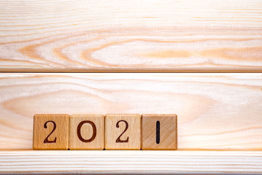 new 2021 year. 2021 New Year Abstract Design Concept. 2021 Text on Wooden Cubes on Wood Background, Table. Closeup of Wooden Number Block Toy with 2021. Banner with Copy Space. Greeting Card Template