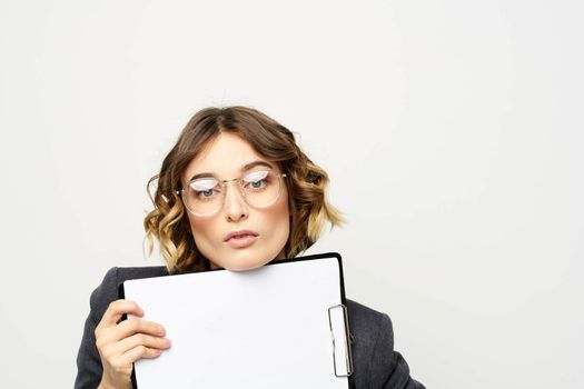 Business woman with a folder of documents on a light background cropped view and shirt suit. High quality photo