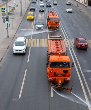 October 7, 2020, Moscow, Russia. Utility vehicles watering the street on a cloudy day.