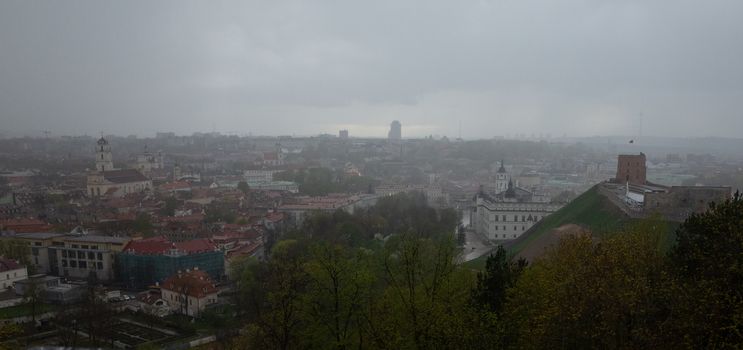 April 27, 2018 Vilnius, Lithuania. View of the old city of Vilnius from Three Cross Mountain in the rain.