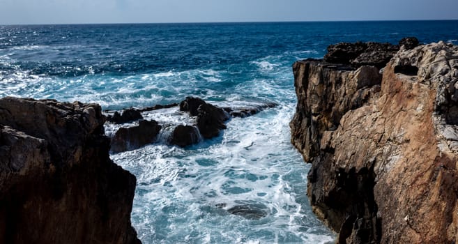 Waves crash on the rocky shore of the Mediterranean Sea on the Akamas Peninsula in the northwest of the island of Cyprus.