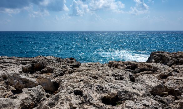 Waves crash on the rocky shore of the Mediterranean Sea on the Akamas Peninsula in the northwest of the island of Cyprus.