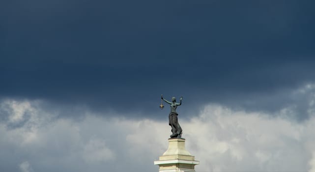 April 27, 2018 Vilnius, Lithuania. Statue of a woman with a lantern and a raised hand at the building of a former power station in Vilnius.