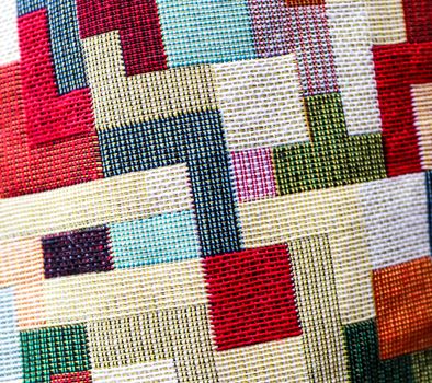 Detailed close up view on samples of cloth and fabrics in different colors found at a fabrics market.