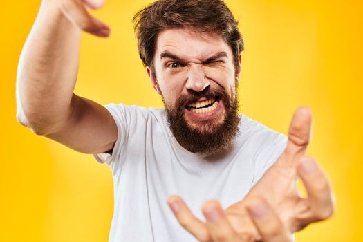 bearded man gesturing with hands studio lifestyle discontent yellow background. High quality photo