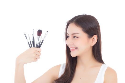 Beauty asian woman applying make up with brush on hand isolated on white background, beautiful of girl holding blusher, skincare and cosmetic concept.