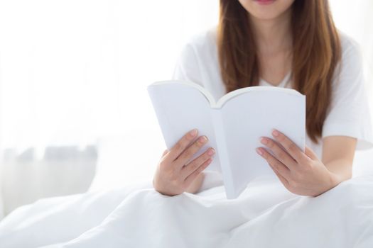 Beautiful of portrait young asian woman relax sitting reading book on bedroom at home, girl study literature, education and llifestyle concept.