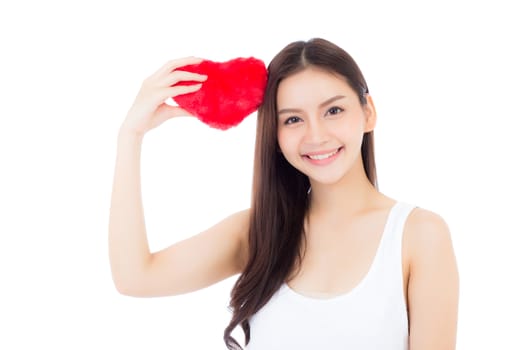 Portrait of beautiful asian young woman holding red heart shape pillow and smile isolated on white background, valentines day, holiday concept.