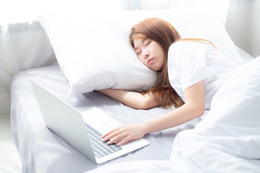 Beautiful of portrait young asian woman with laptop lying down in bedroom, girl tired sleep and relax with computer notebook, resting and healthcare concept.