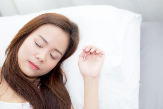 Portrait of beautiful asian young woman sleep lying in bed with head on pillow comfortable and happy with leisure, girl with relax  for health and lifestyle concept.