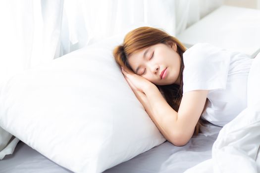 Portrait of beautiful asian young woman sleep lying in bed with head on pillow comfortable and happy with leisure, girl with relax  for health and lifestyle concept.