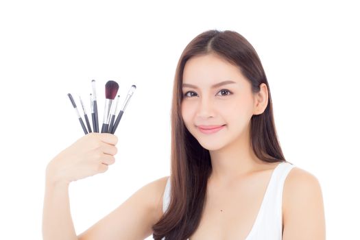 Beauty asian woman applying make up with brush on hand isolated on white background, beautiful of girl holding blusher, skincare and cosmetic concept.