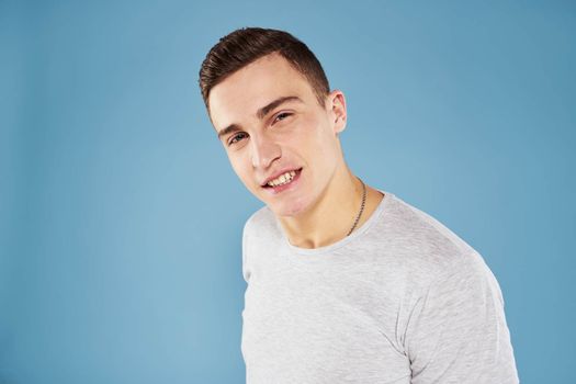 Emotional man in white t-shirt cropped view on blue background lifestyle. High quality photo