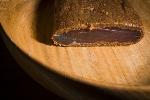 Piece of smoked meat on wooden board