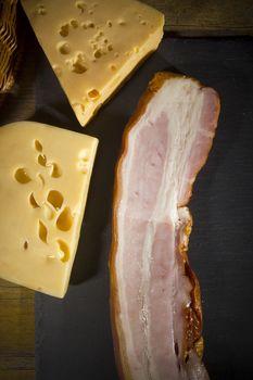 Cheese and bacon on a cutting stone board