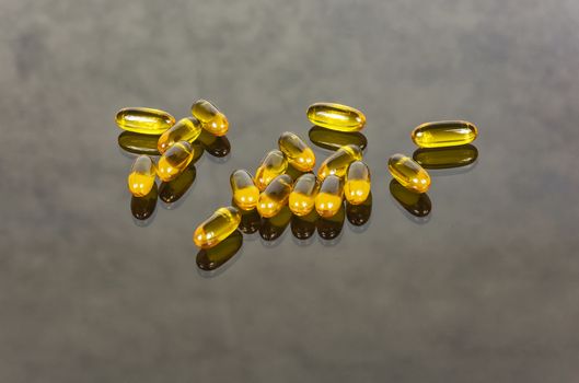 Capsules with medicine lie on a glass surface