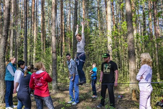 A woman trains to walk on a tight rope with insurance