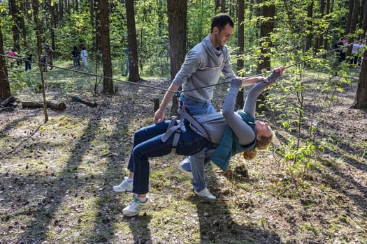 A man insures a woman hanging on a rope