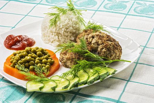 Home food. Cutlets with boiled rice and vegetables