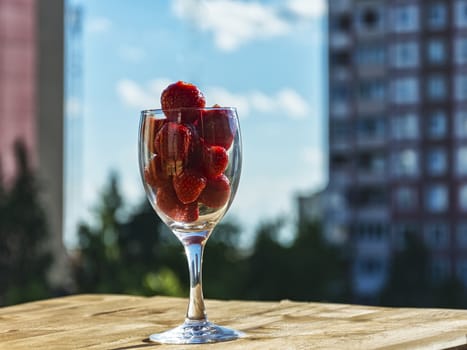 Strawberries in a glass against the blue sky