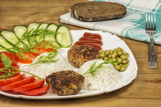 Homemade food. Fresh vegetables and boiled rice with meat ribs