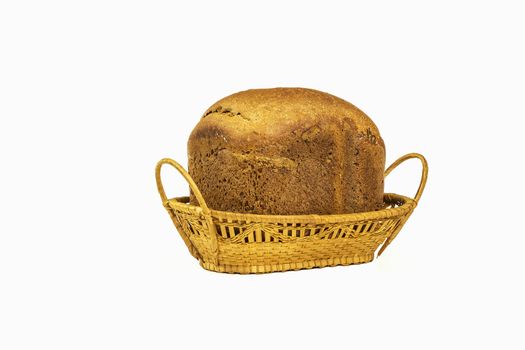 Wicker basket with a loaf of bread on a white background