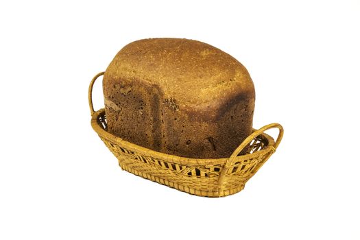 On a white background stands Wicker basket with a loaf of bread on a white background