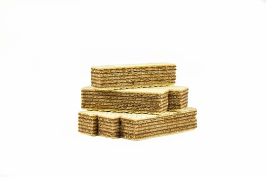 Several strips of waffle dessert with chocolate filling lie on a light background