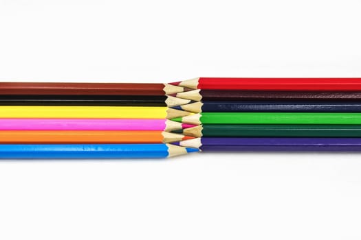 On a white background there are multicolored sharpened pencils for drawing