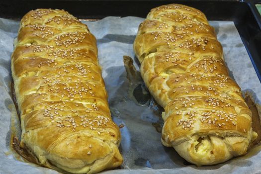 Fresh strudels on baking sheets