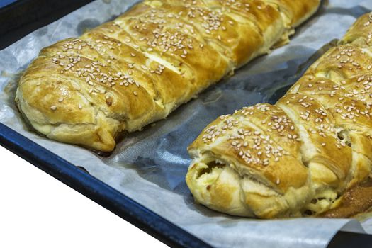 Two fresh baked strudels on a baking tray