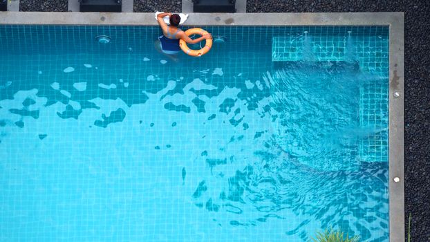 Water streaming corner in swimming pool top view and people enjoyed together on summer vacation day.