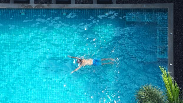 Water streaming corner in swimming pool top view and people enjoyed together on summer vacation day.