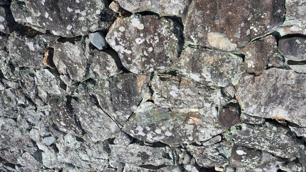 Texture of big real rock stone wall old and dirty on japan Himeji castle in sunny summer day.