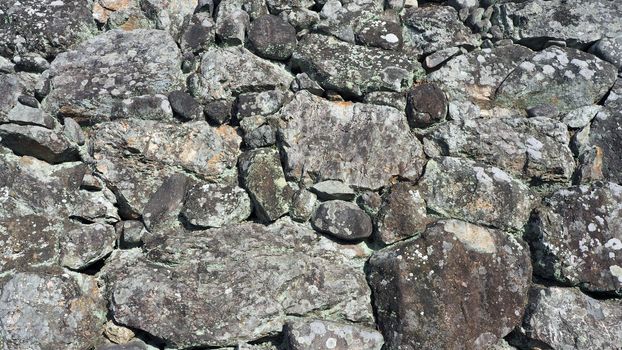 Texture of big real rock stone wall old and dirty on japan Himeji castle in sunny summer day.