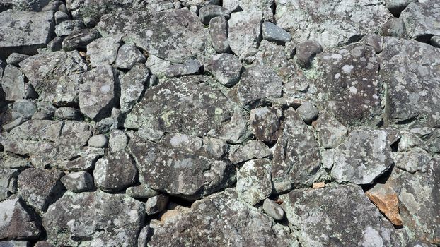 Texture of big real rock stone wall old and dirty on japan Himeji castle in sunny summer day.