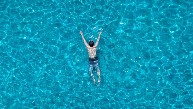 Swimming pool blue color clear water and people enjoying in summer sunny day and top view angle.