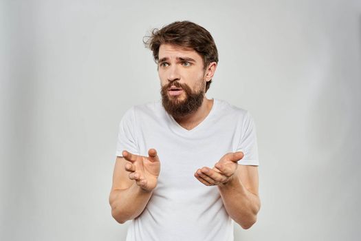 Bearded man gesturing with hand white cropped t-shirt studio lifestyle. High quality photo