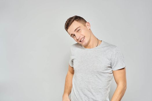 handsome man in light t-shirt cropped view emotion studio isolated background. High quality photo