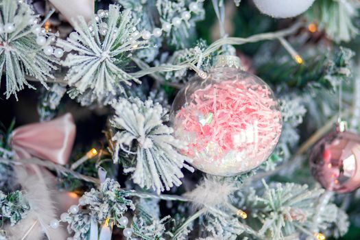 Christmas tree decoration close-up. Christmas tree decor elements in gentle trendy colors. Background for postcards. Unusual Christmas ball