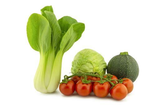 Chinese cabbage and white cabbage green round courgette or zucchini and cherry tomato twig isolated on white background
