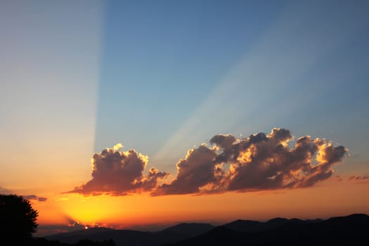 Mountain cloudscape and landscape at sunset in Georgia. Horizon in mountain range.cloudy vivid sunlight, fire storm cloudy view.