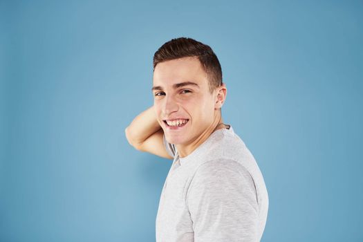 Emotional man in white t-shirt cropped view on blue background lifestyle. High quality photo