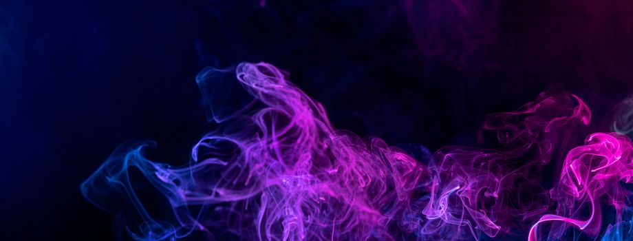 Conceptual image of colorful red and blue color smoke isolated on dark black background, Halloween concept design element.