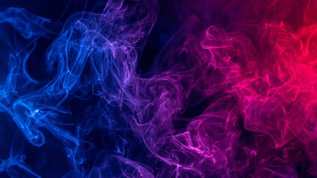 Conceptual image of colorful red and blue color smoke isolated on dark black background, Halloween concept design element.