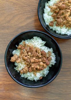 Braised meat rice, stewed pork over cooked rice in Tainan, Taiwan. Taiwanese famous traditional street food delicacy. Travel design concept, closeup.