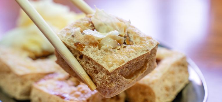 Deep fried stinky tofu, fermented bean curd with pickled cabbage vegetable, famous and delicious street food in Taiwan, lifestyle.