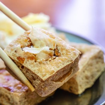 Deep fried stinky tofu, fermented bean curd with pickled cabbage vegetable, famous and delicious street food in Taiwan, lifestyle.