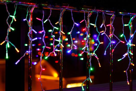 Christmas garland lights with window reflection